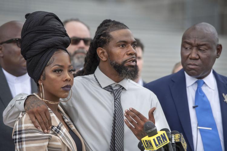 Shedric Cole, center, gestures toward his fiancée, Baton Rouge's Nancy Davis, left, as they and nationally renowned civil rights and personal injury attorney Ben Crump, right, hold a news conference on the steps of the State Capitol, Friday, August 26, 2022, discussing the chain of events and potential legal action after a Baton Rouge hospital denied Davis, 36, an abortion for her fetus, which is developing without a skull.